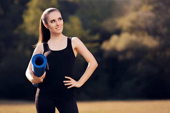 Girl with Yoga Mat Standing Outdoor